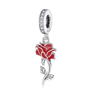 Detailed macro view of S925 silver red rose charm with sparkling cubic zirconia inlay