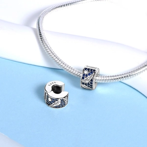 Silver feather and heart charm with blue zircon stones on a snake chain bracelet