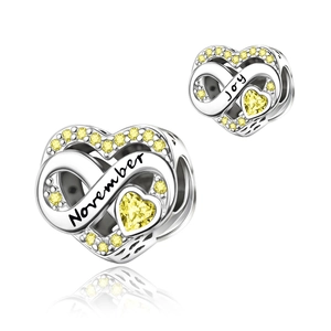 Detail showing November heart charm with yellow stone and infinity joy engraving