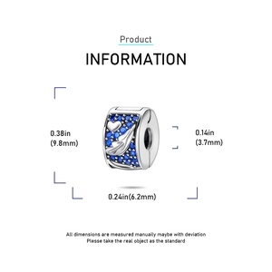 Macro detail of silver charm bead with dark blue stones and heart engraving motifs