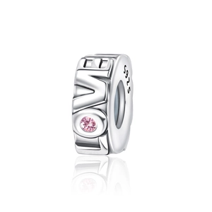 Detailed view of silver charm with LOVE engraving and pink gemstone inlay