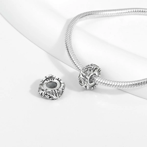 Close-up of S925 sterling silver hollow leaf charm with cubic zirconia on a snake chain