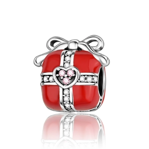 Detail of red enamel gift box charm with silver bow and sparkling zircon heart