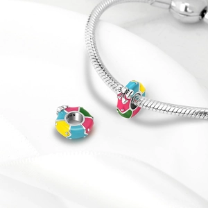 Macro view of S925 sterling silver colorful enamel charm beads on a snake chain bracelet
