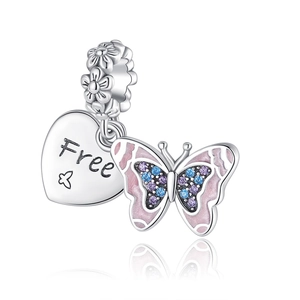 Macro detail of silver butterfly charm with pink enamel, crystals and heart pendant