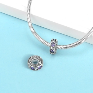 Detail of silver heart charm with purple zircons and scrollwork on snake chain