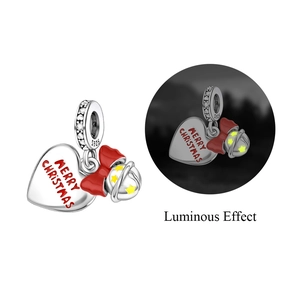 Detailed S925 silver Christmas charm with luminous bell and red bow in dark light