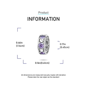 Macro detail of heart-shaped silver charm with purple stones and swirl patterns