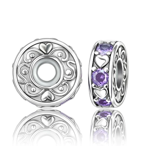 Detail of silver heart charm bead with purple cubic zirconia and scroll relief