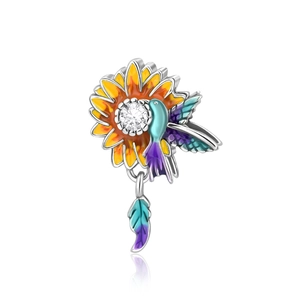 Detail of hummingbird and sunflower charm with colorful enamel and sparkling zircon