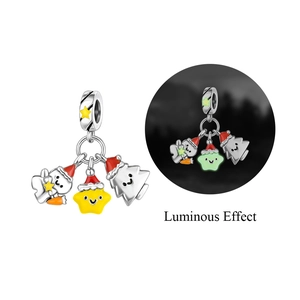 Detailed macro view of luminous Christmas charms with snowman and star in dark