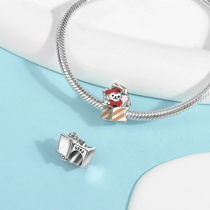 Close-up of S925 sterling silver cat in gift box charm with red bow and fine orange enamel