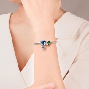 Silver dragonfly and butterfly charm bracelet with blue floral enamel beads on snake chain