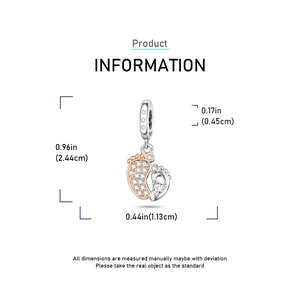 Detailed view of silver baby feet pendant with rose gold plating and heart zircon