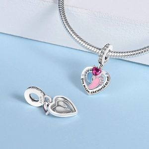 Macro detail of S925 silver heart pendant with pink paw prints and purple zircon stone