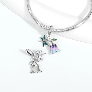 Detail of S925 silver dragonfly and lily of the valley charm with enamel and cubic zirconia