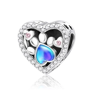 Macro detail of S925 silver heart charm with pet paw print and blue opal stone