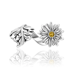 Detailed macro view of silver insect series ring with leaf and yellow gemstone flower