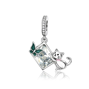 Silver cat charm with rectangular clear zircon and green butterfly pendant on white base