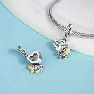 Detail view of heart-shaped S925 silver charm with yellow enamel corgi on snake chain