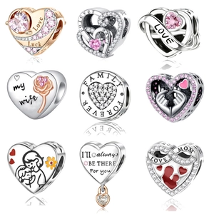 Macro detail of nine S925 silver heart charms with rose gold plating and zircon inlay
