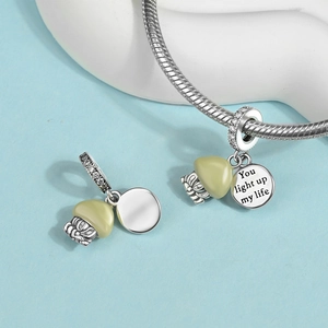 Detail of silver drop charm with You Light Up My Life engraving on a snake chain