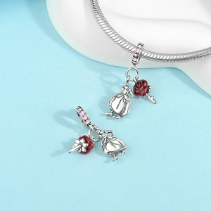 Macro detail of silver female figure charm with pink zircons and a red rose element