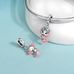 Close-up of S925 sterling silver axolotl charms with pink enamel and colorful zircons