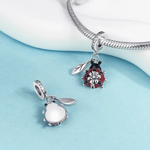 Detailed macro view of S925 silver ladybug charm with red enamel and leaf pendant