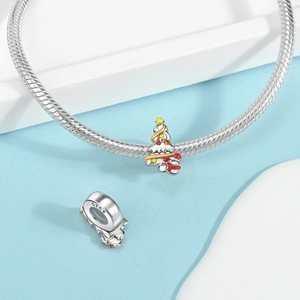 Macro detail of S925 sterling silver Christmas tree charm with colorful enamel on a bracelet
