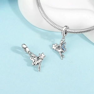 Macro detail of silver fairy charm with blue crystals and S925 engraved hallmark
