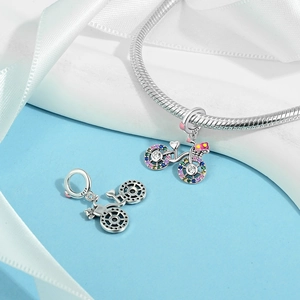 Detailed close-up of S925 sterling silver bicycle charm with rainbow cubic zirconia wheels