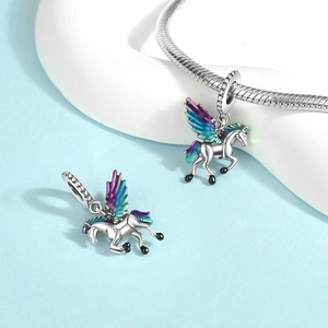 Macro detail of Pegasus charm with iridescent wings on a silver snake chain bracelet