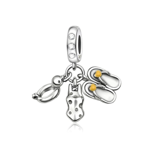 Macro detail of S925 silver beach charms with flip-flops and swimsuit on white background