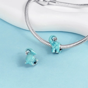 Macro shot of silver elephant charm with light blue enamel and small flower detail