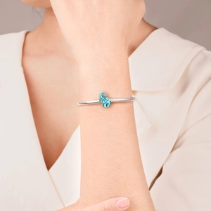 Silver snake chain bracelet featuring a light blue enamel elephant charm with a small crystal