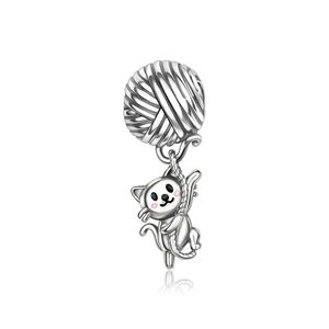 Detailed close-up of a silver-plated cat pendant climbing a polished yarn ball bead