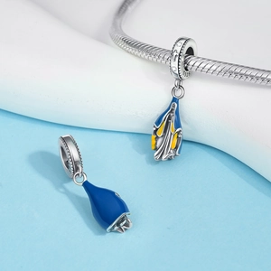 Close-up of S925 sterling silver religious charms with blue and yellow enamel details
