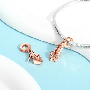 Macro detail of rose gold high heel charms with S925 engraving and pavé crystal bows