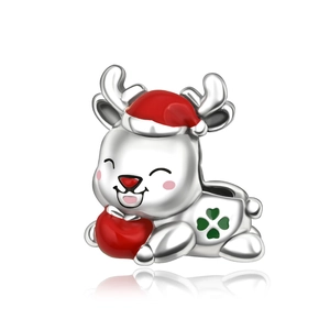 Macro detail of Christmas reindeer charm with red enamel hat and green clover accents