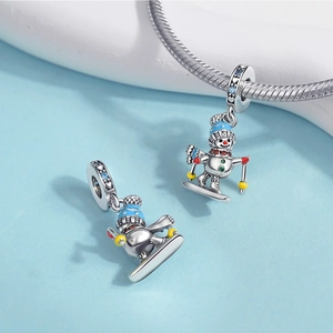 Macro detail of snowman charm with blue enamel hat and zircon stones for silver bracelets