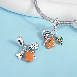 Macro shot of S925 sterling silver Christmas charms with gingerbread and snowflake details