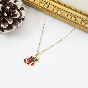 Close-up of a festive red Christmas stocking pendant with a delicate gold chain link