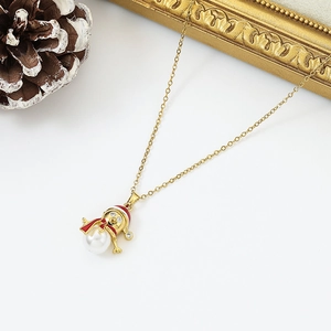 Golden Christmas necklace with snowman pendant featuring pearl body and red hat on white background