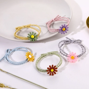 Five-piece daisy and bow hair ties set in macaroon colors on a decorative tray