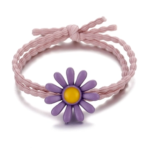 Close-up of pink elastic hair tie with a detailed purple daisy flower ornament