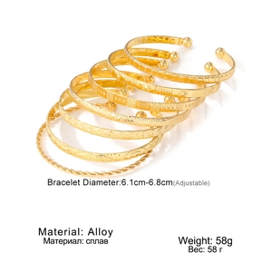 Detail showing 6-piece gold alloy adjustable bracelet set with various textures and stars