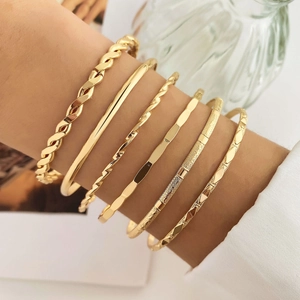 Set of 6 gold metal bangles featuring twisted rope and geometric textured patterns