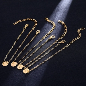 Minimalist gold chain bracelets with circular charms featuring LOVE letter engravings