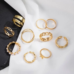 10-teiliges goldenes Ring-Set mit Schmetterling und Herz auf edlem Marmorhintergrund